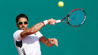 janko tipsarevic returns the ball