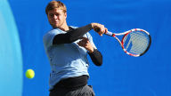 ryan harrison returns the ball